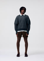 A model wears the HOMME PLISSÉ ISSEY MIYAKE TAILORED PLEATS 3 tailored-pleats-3-trousers-duomo-green-1.