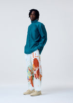 A model wears the HOMME PLISSÉ ISSEY MIYAKE PALETTE trousers.