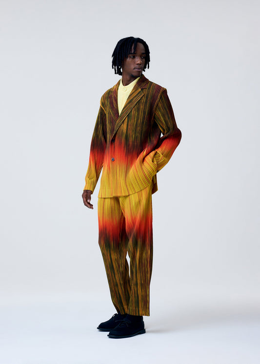 A model wears the HOMME PLISSÉ ISSEY MIYAKE PAINT BRUSH CLOSE UP trousers.