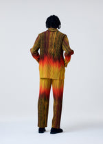 A model wears the HOMME PLISSÉ ISSEY MIYAKE PAINT BRUSH CLOSE UP trousers.