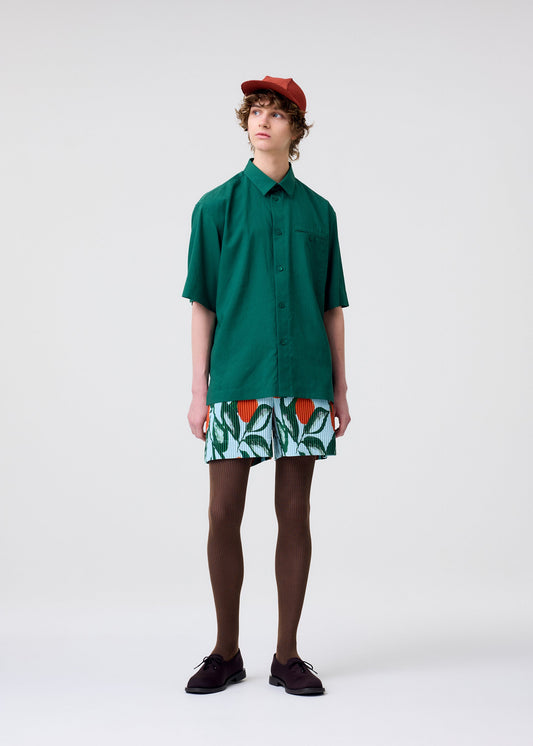 A model wears the HOMME PLISSÉ ISSEY MIYAKE FRUITS & VEGETABLES shorts.