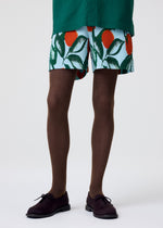 A model wears the HOMME PLISSÉ ISSEY MIYAKE FRUITS & VEGETABLES shorts.
