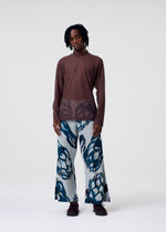 A model wears the HOMME PLISSÉ ISSEY MIYAKE FRUITS & VEGETABLES trousers.