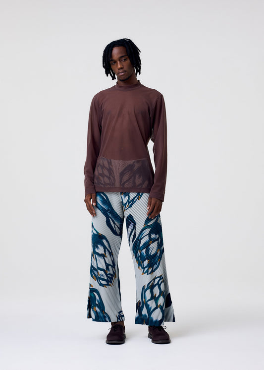 A model wears the HOMME PLISSÉ ISSEY MIYAKE FRUITS & VEGETABLES trousers.