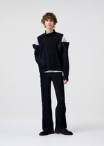 A model wears the HOMME PLISSÉ ISSEY MIYAKE MULTI-FASTENED multi-fastened-trousers-pizza-scorch-brown.