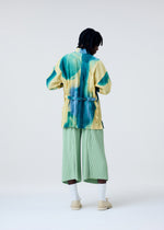 A model wears the HOMME PLISSÉ ISSEY MIYAKE PLEATS BOTTOMS 2 trousers.