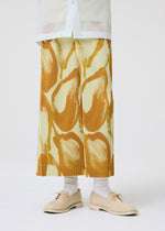 A model wears the HOMME PLISSÉ ISSEY MIYAKE FRUITS & VEGETABLES skirt.