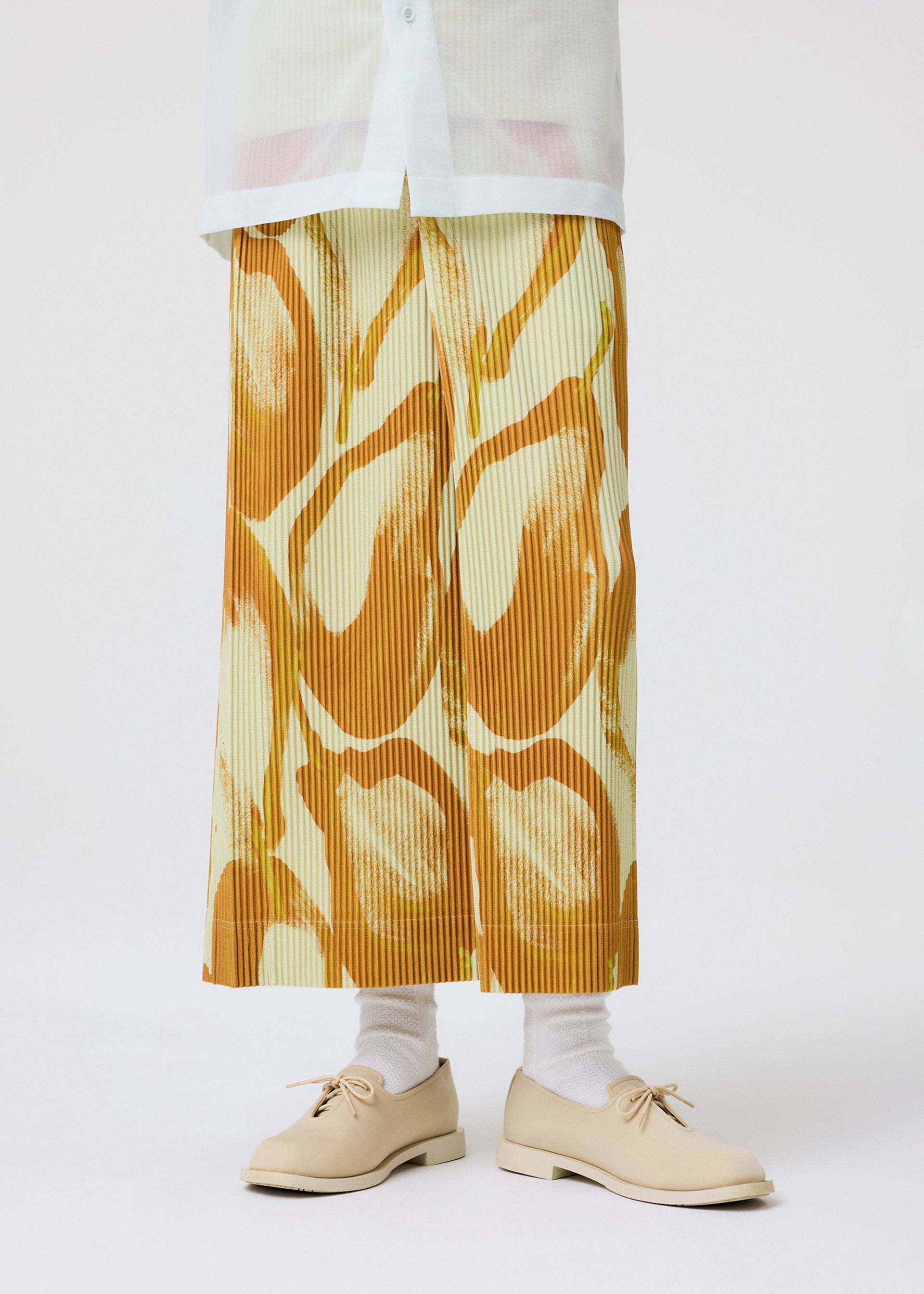 A model wears the HOMME PLISSÉ ISSEY MIYAKE FRUITS & VEGETABLES skirt.