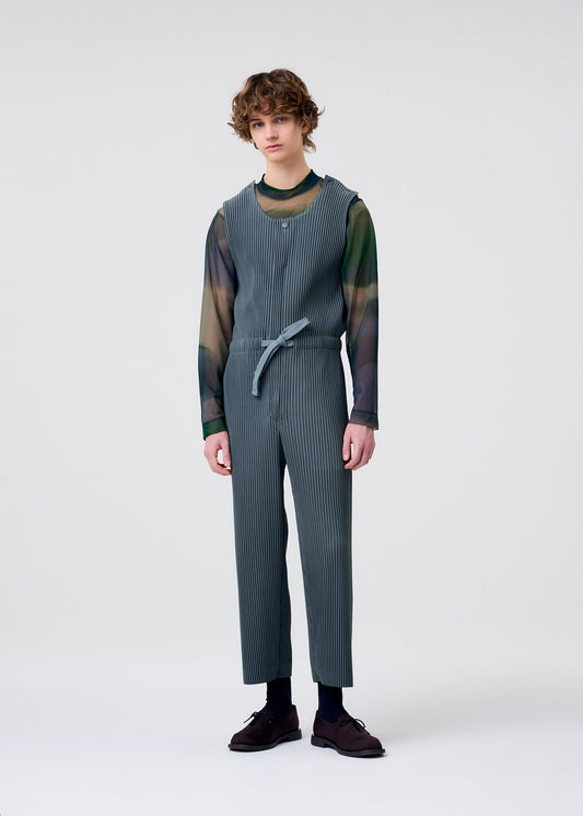 A model wears the HOMME PLISSÉ ISSEY MIYAKE PLEATS BOTTOMS 2 jumpsuit.