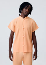 A model wears the HOMME PLISSÉ ISSEY MIYAKE MONTHLY COLORS APRIL shirt.
