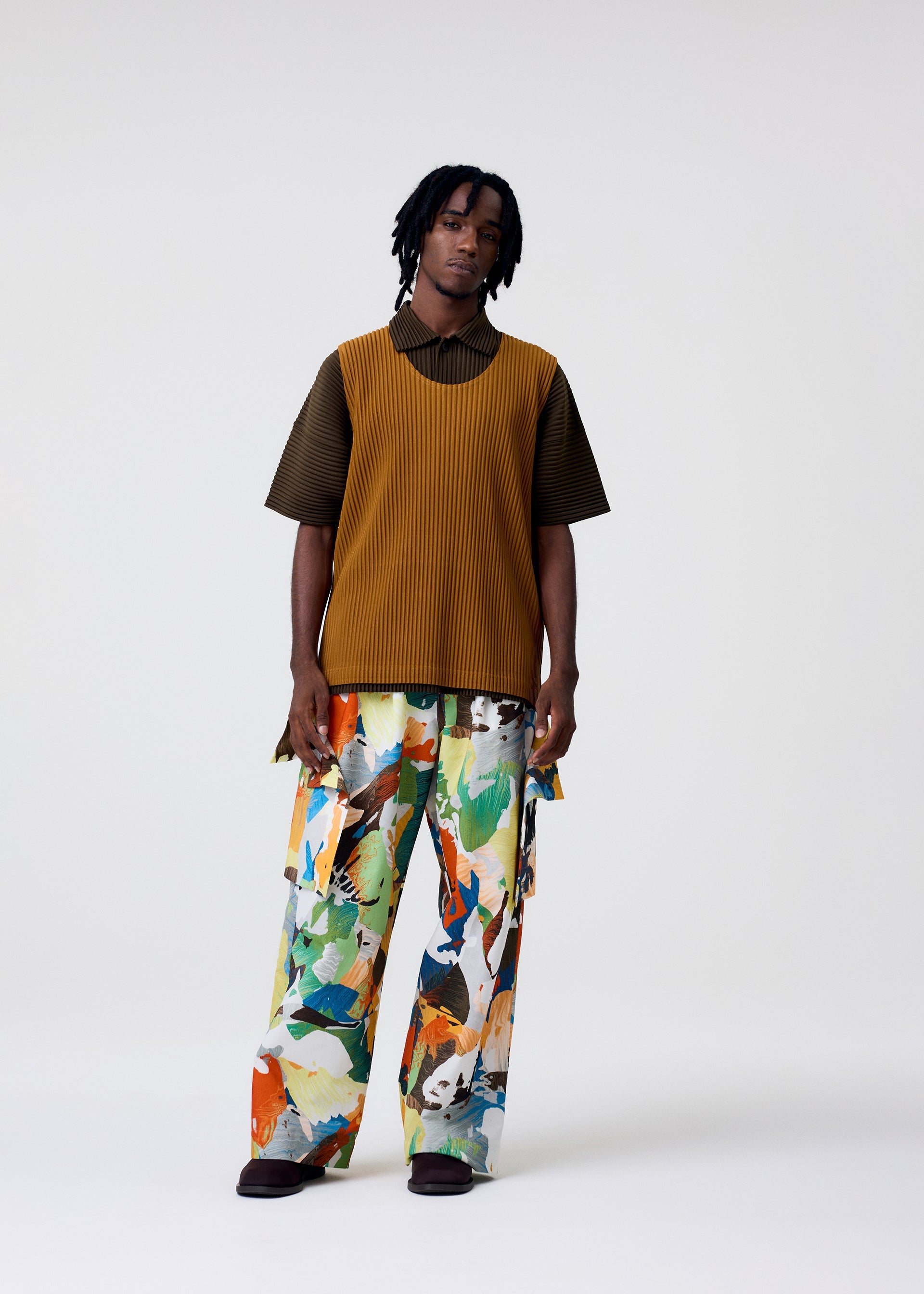 A model wears the HOMME PLISSÉ ISSEY MIYAKE MONTHLY COLORS : JUNE monthly-colors-june-top-venice-boat-brown.