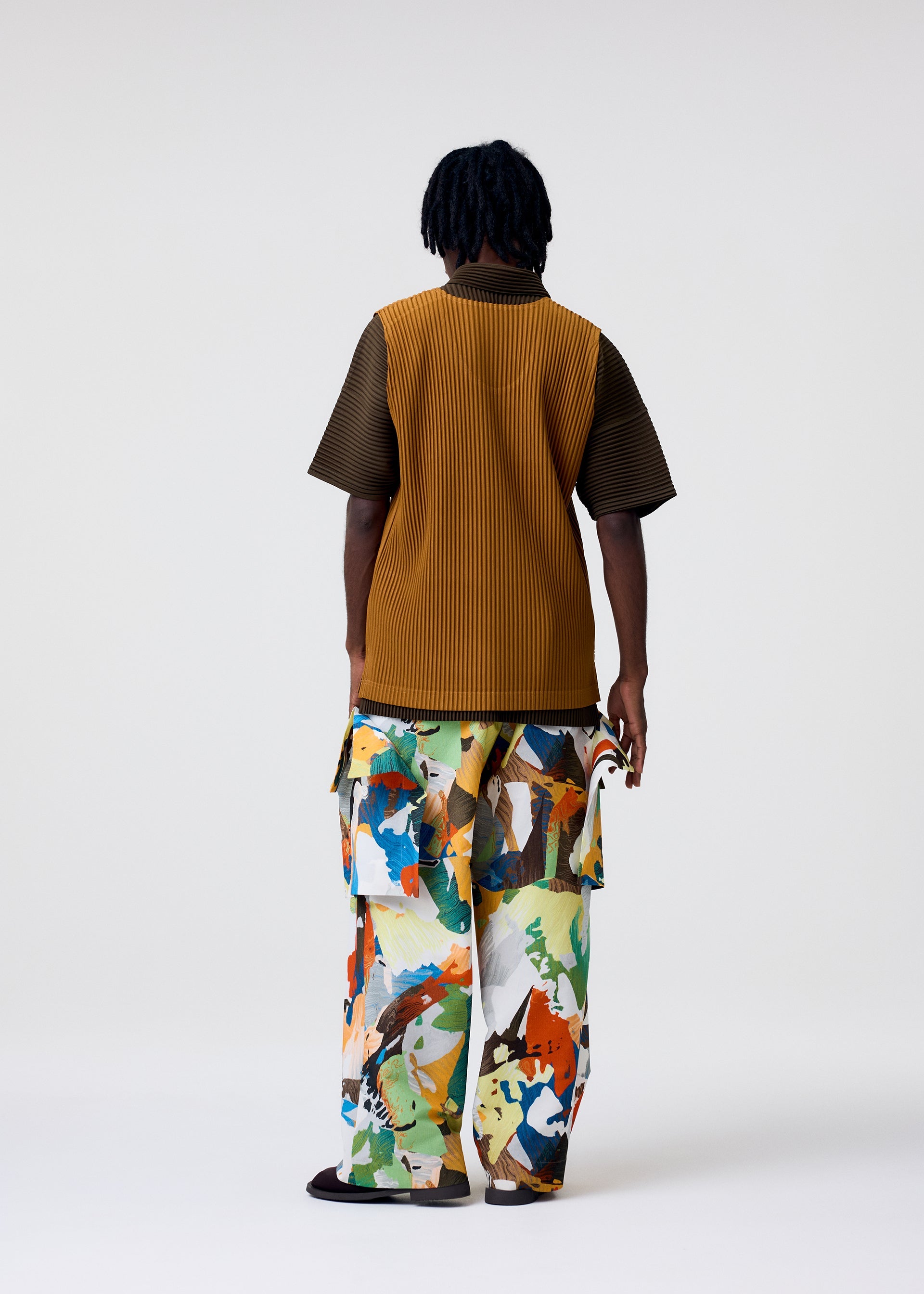 A model wears the HOMME PLISSÉ ISSEY MIYAKE MONTHLY COLORS : JUNE monthly-colors-june-top-genova-metal-ochre.