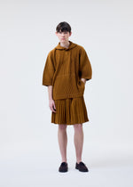 A model wears the HOMME PLISSÉ ISSEY MIYAKE MONTHLY COLORS : JUNE monthly-colors-june-top-genova-metal-ochre-1.