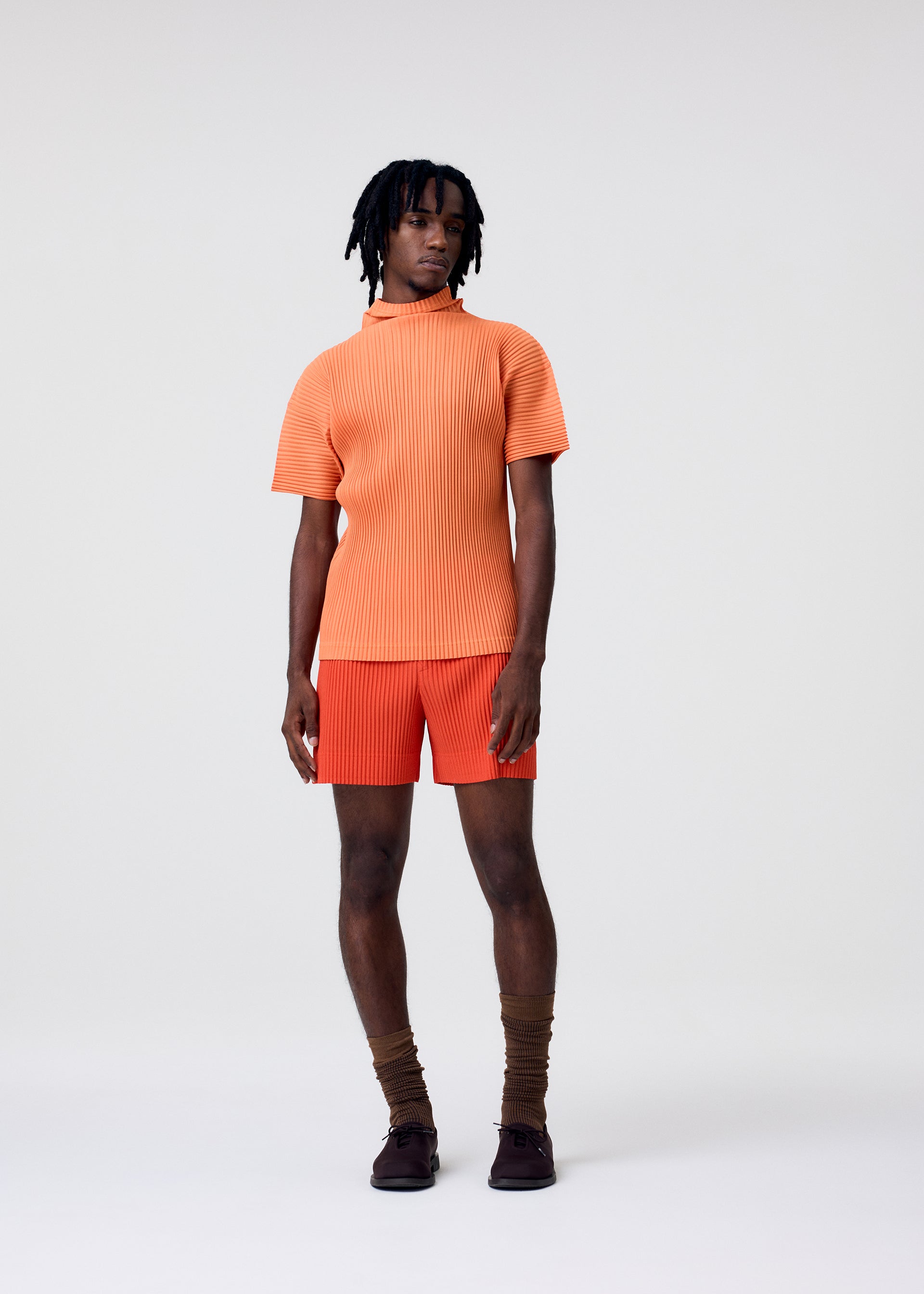 A model wears the HOMME PLISSÉ ISSEY MIYAKE AGAVE MESH agave-mesh-top-light-grey.