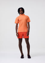 A model wears the HOMME PLISSÉ ISSEY MIYAKE AGAVE MESH agave-mesh-top-light-grey.