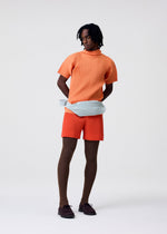 A model wears the HOMME PLISSÉ ISSEY MIYAKE AGAVE MESH agave-mesh-top-black.