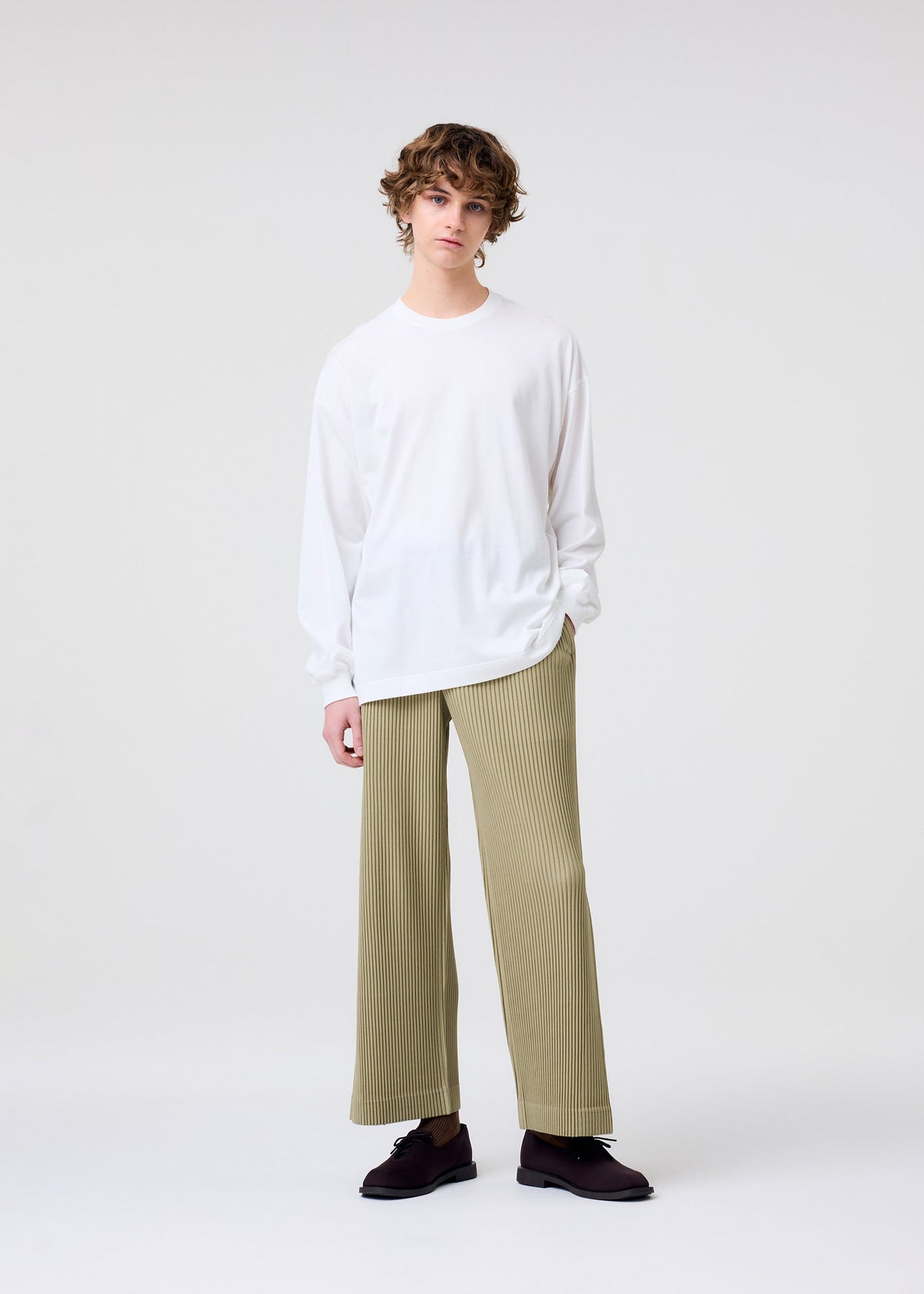 A model wears the HOMME PLISSÉ ISSEY MIYAKE COLOR CHIPS T SHIRT top.