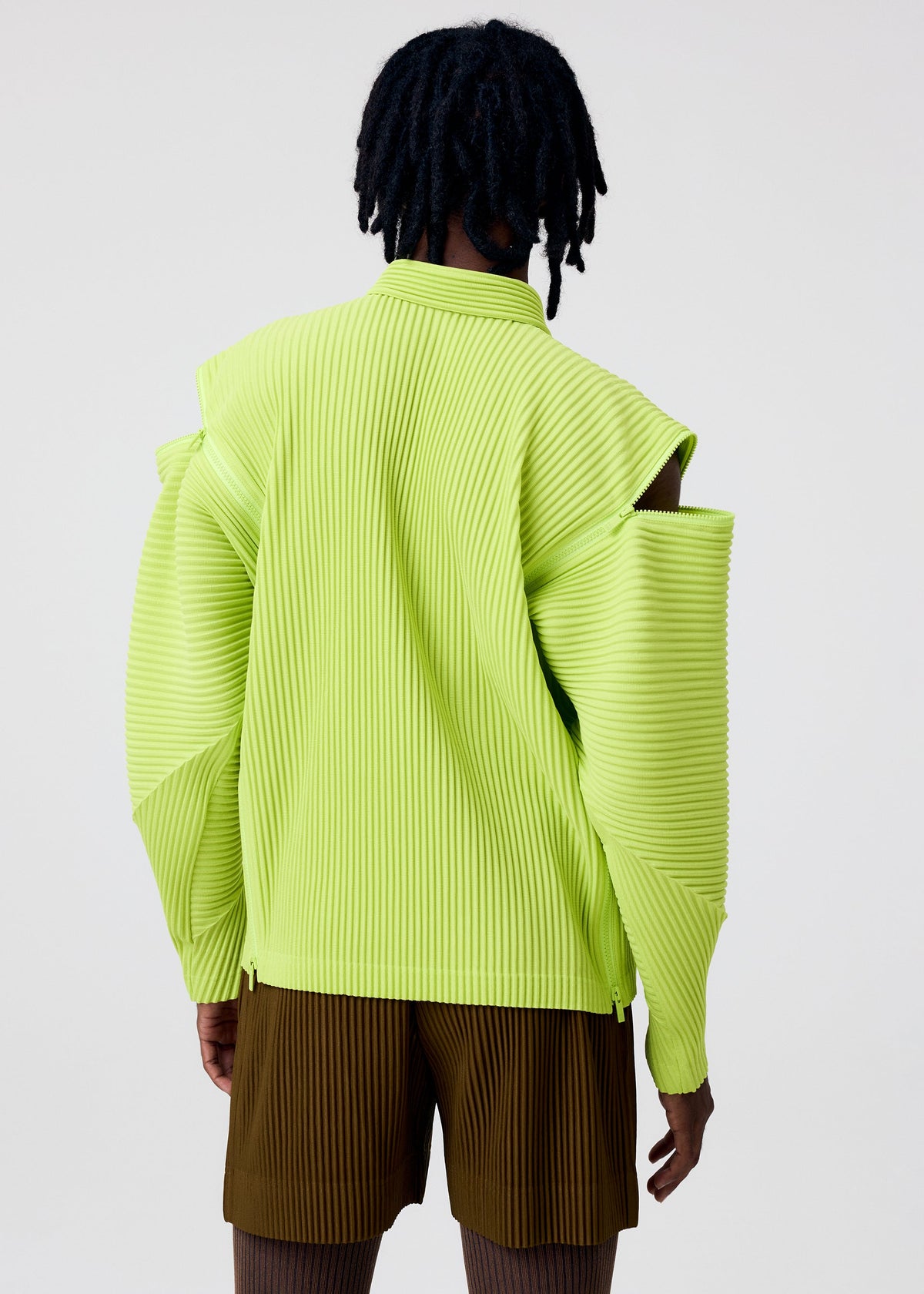 A model wears the HOMME PLISSÉ ISSEY MIYAKE MULTI-FASTENED multi-fastened-shirt-pizza-scorch-brown.