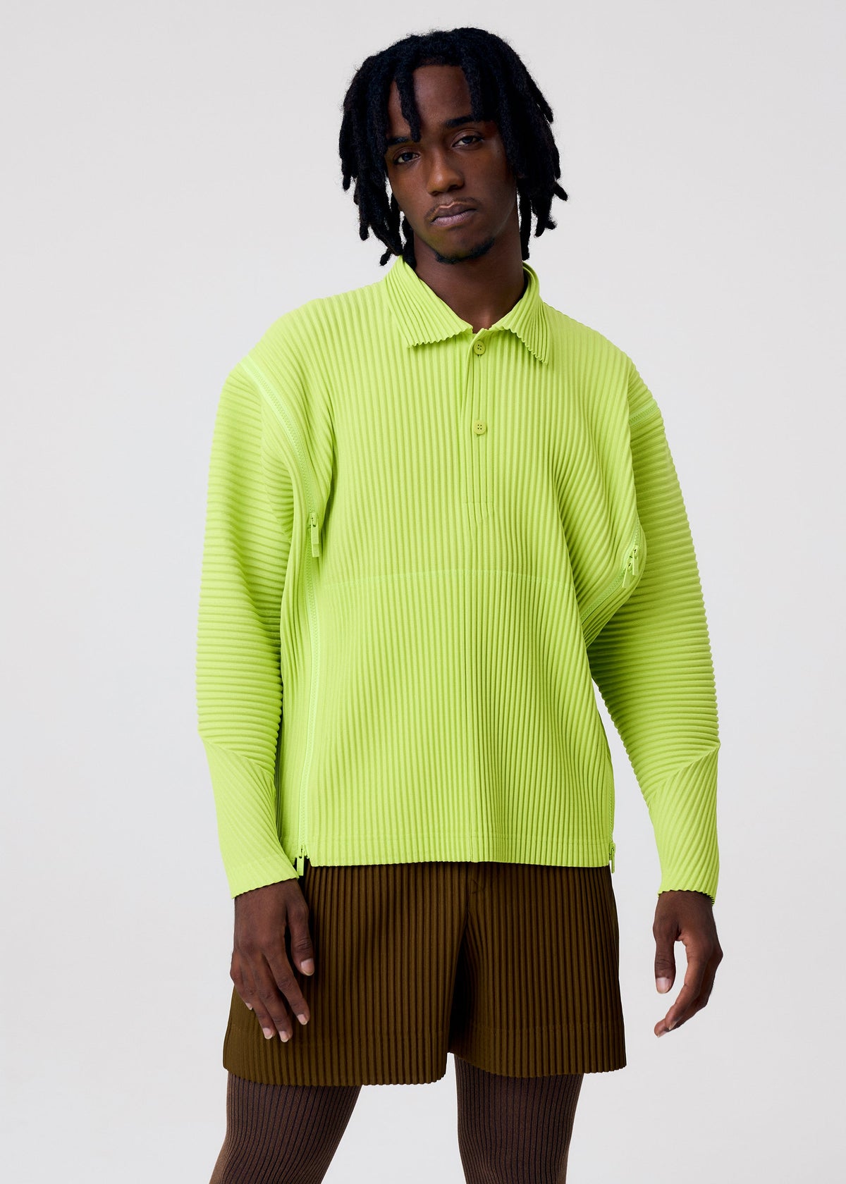 A model wears the HOMME PLISSÉ ISSEY MIYAKE MULTI-FASTENED multi-fastened-shirt-lucca-storico-blue.