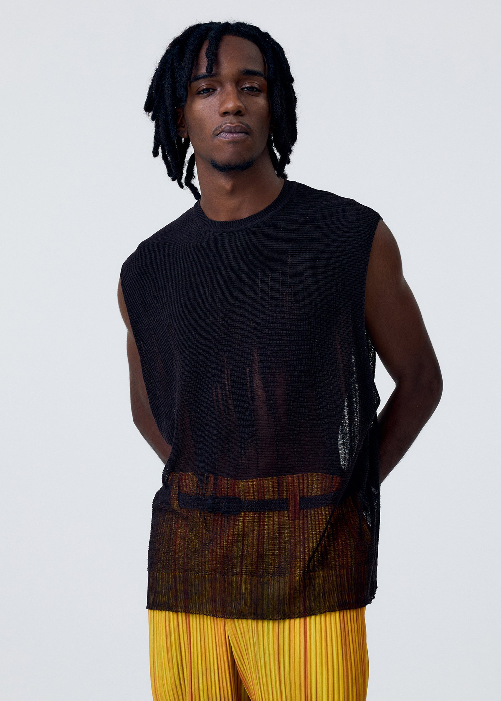 A model wears the HOMME PLISSÉ ISSEY MIYAKE BRUSH CLOSE UP KNIT vest.