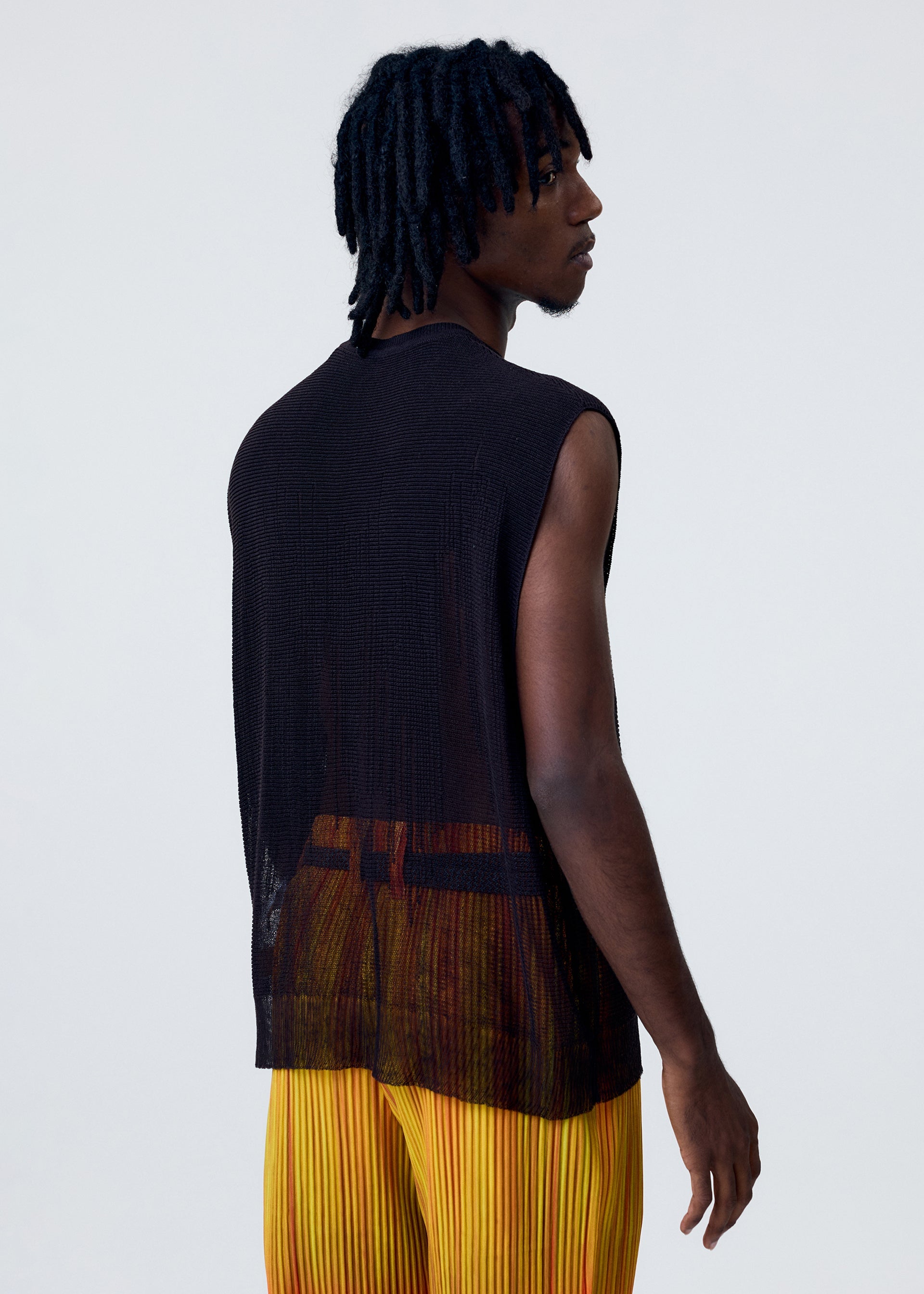 A model wears the HOMME PLISSÉ ISSEY MIYAKE BRUSH CLOSE UP KNIT vest.