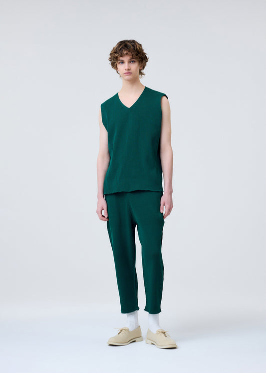 A model wears the HOMME PLISSÉ ISSEY MIYAKE BASIC KNIT clothing.