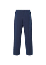 A detail shot of the HOMME PLISSÉ ISSEY MIYAKE INLAID KNIT trousers.