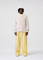 A model wears the HOMME PLISSÉ ISSEY MIYAKE RISOTTO KNIT top.