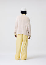 A model wears the HOMME PLISSÉ ISSEY MIYAKE RISOTTO KNIT top.