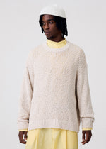 A model wears the HOMME PLISSÉ ISSEY MIYAKE RISOTTO KNIT top.