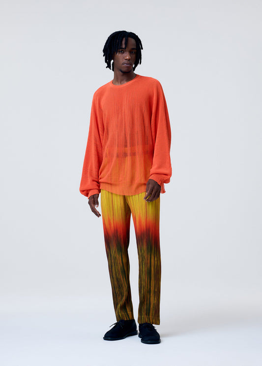 A model wears the HOMME PLISSÉ ISSEY MIYAKE BRUSH CLOSE UP KNIT top.