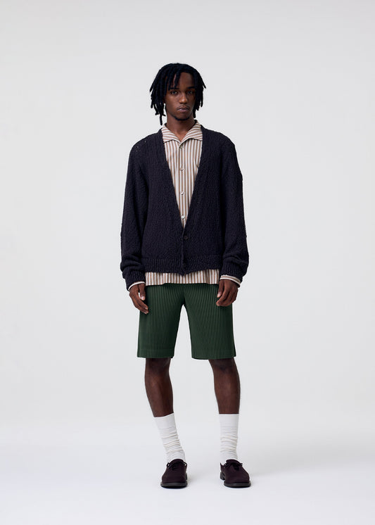 A model wears the HOMME PLISSÉ ISSEY MIYAKE RISOTTO KNIT cardigan.