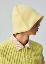 A model wears the HOMME PLISSÉ ISSEY MIYAKE WINTER GEAR : COLOR BLOCK winter-gear-color-block-reversable-cap-navy.