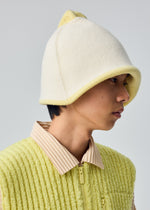 A model wears the HOMME PLISSÉ ISSEY MIYAKE WINTER GEAR : COLOR BLOCK winter-gear-color-block-reversable-cap-navy.