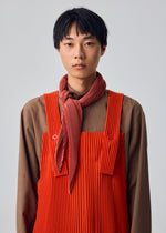 A model wears the HOMME PLISSÉ ISSEY MIYAKE PLEATS STOLE pleats-stole-stole-yellow.