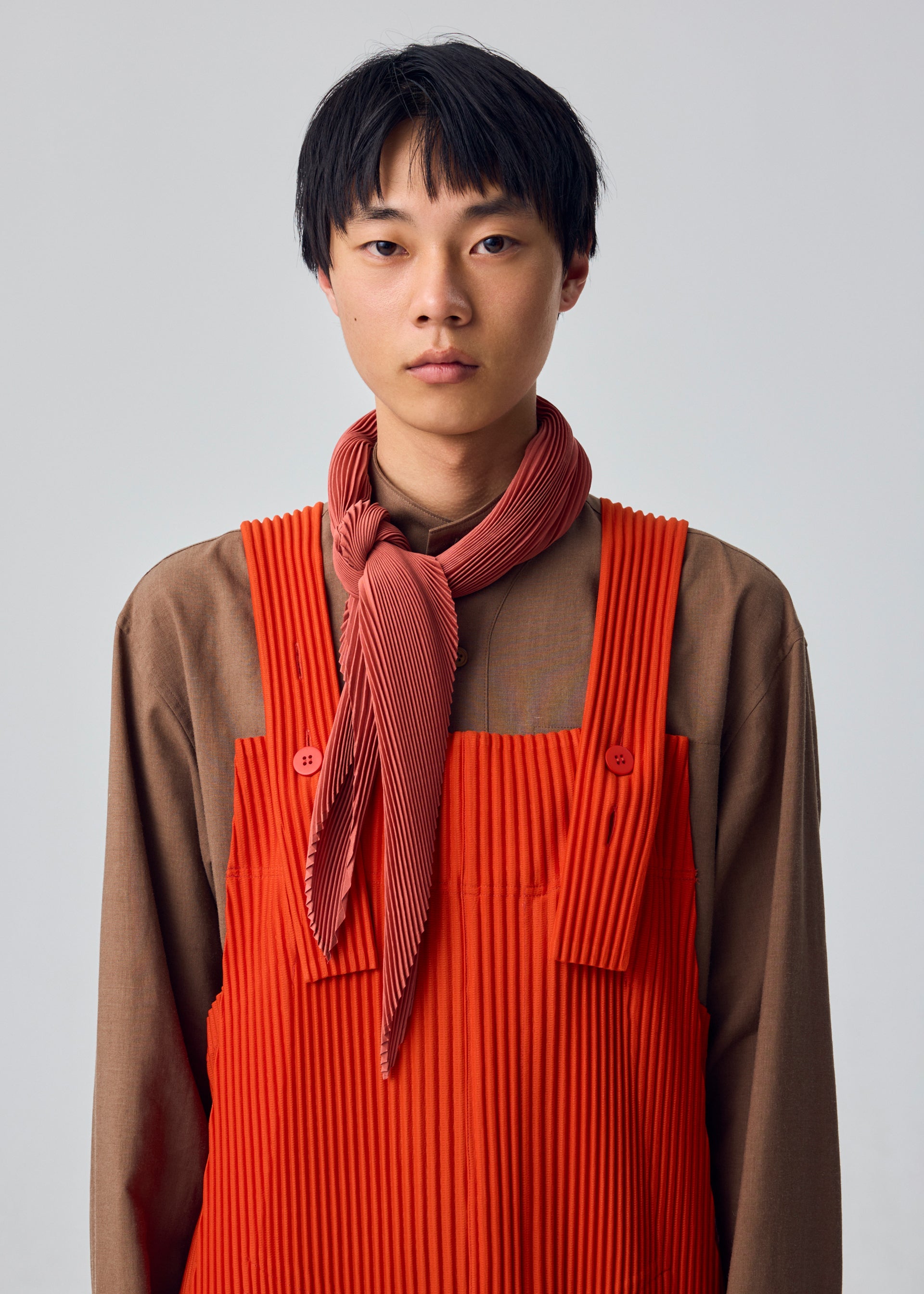 A model wears the HOMME PLISSÉ ISSEY MIYAKE PLEATS STOLE pleats-stole-stole-yellow.