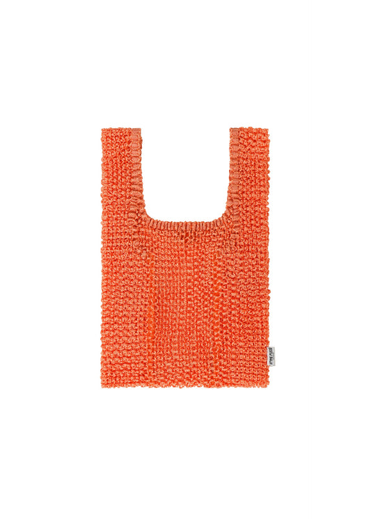 A product shot of the HOMME PLISSÉ ISSEY MIYAKE MESH PLEATS BAG tote in orange.