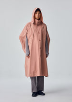 A model wears the HOMME PLISSÉ ISSEY MIYAKE SLIT COAT slit-coat-coat-green.