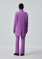 A model wears the HOMME PLISSÉ ISSEY MIYAKE KERSEY PLEATS kersey-pleats-classic-cut-trousers-blue-grey.