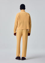 A model wears the HOMME PLISSÉ ISSEY MIYAKE TAILORED PLEATS 1 tailored-pleats-1-raglan-jacket-shadow-brown.
