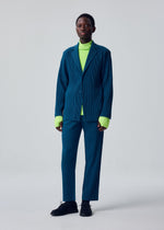 A model wears the HOMME PLISSÉ ISSEY MIYAKE TAILORED PLEATS 1 tailored-pleats-1-jacket-shadow-blue.