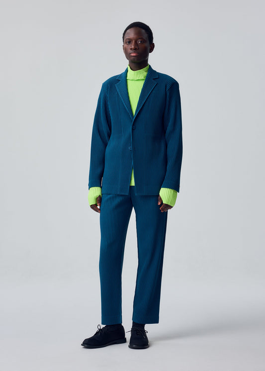 A model wears the HOMME PLISSÉ ISSEY MIYAKE TAILORED PLEATS 1 tailored-pleats-1-jacket-shadow-blue.