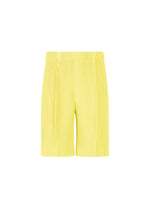 A product shot of the HOMME PLISSÉ ISSEY MIYAKE MONTHLY COLORS : AUGUST shorts in shine yellow.