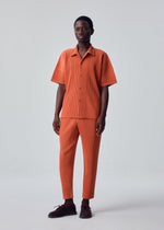 A model wears the HOMME PLISSÉ ISSEY MIYAKE MONTHLY COLORS : AUGUST monthly-colors-august-trousers-inky-grey.