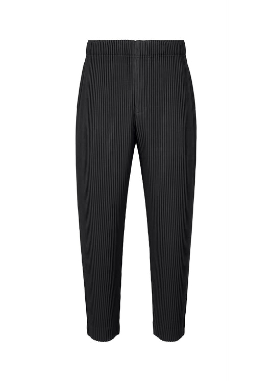 A product shot of the HOMME PLISSÉ ISSEY MIYAKE MONTHLY COLORS : AUGUST trousers in black.