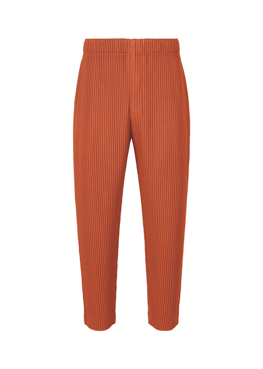 A product shot of the HOMME PLISSÉ ISSEY MIYAKE MONTHLY COLORS : AUGUST trousers in shade vermillion.