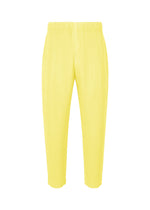 A product shot of the HOMME PLISSÉ ISSEY MIYAKE MONTHLY COLORS : AUGUST trousers in shine yellow.