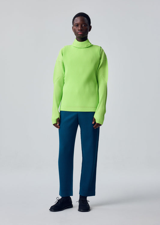 A model wears the HOMME PLISSÉ ISSEY MIYAKE TAILORED PLEATS 1 tailored-pleats-1-trousers-shadow-blue.