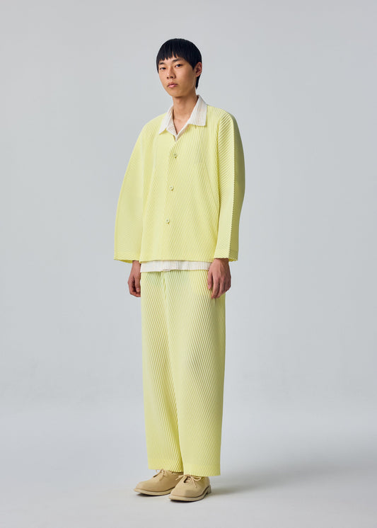 A model wears the HOMME PLISSÉ ISSEY MIYAKE SLASH slash-trousers-dim-green.