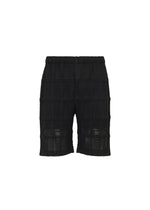 A product shot of the HOMME PLISSÉ ISSEY MIYAKE LACE GRID PLEATS shorts in black.